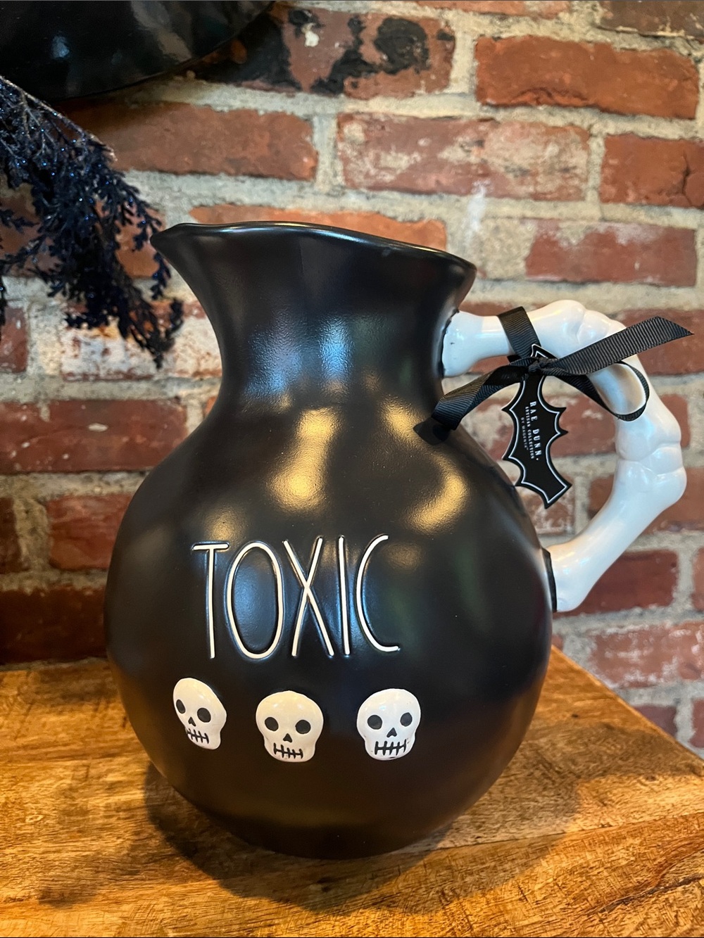Rae Dunn Black 'TOXIC' Pitcher with White Bone Handle and Skulls